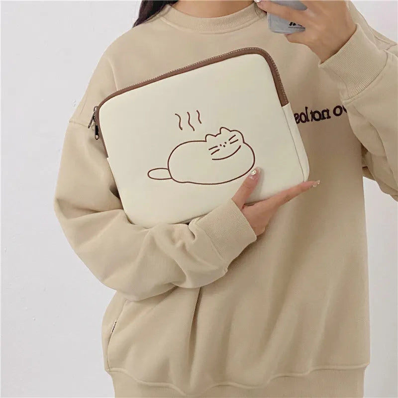 Embroidered cat design nylon tablet protective sleeve with zipper closure.