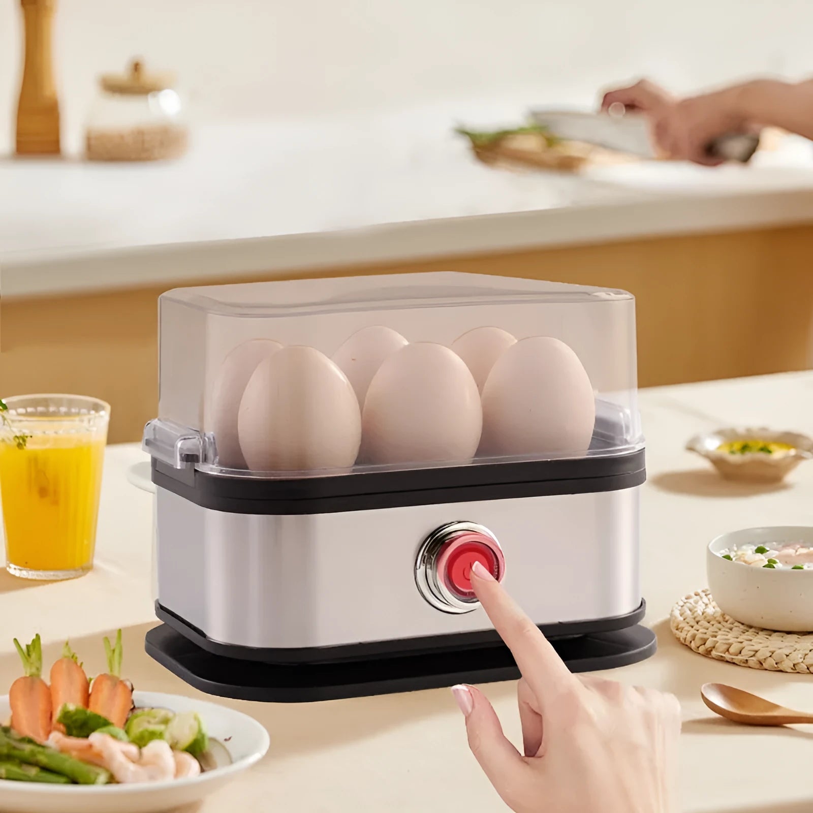 Black stainless steel mini portable electric egg boiler on a countertop