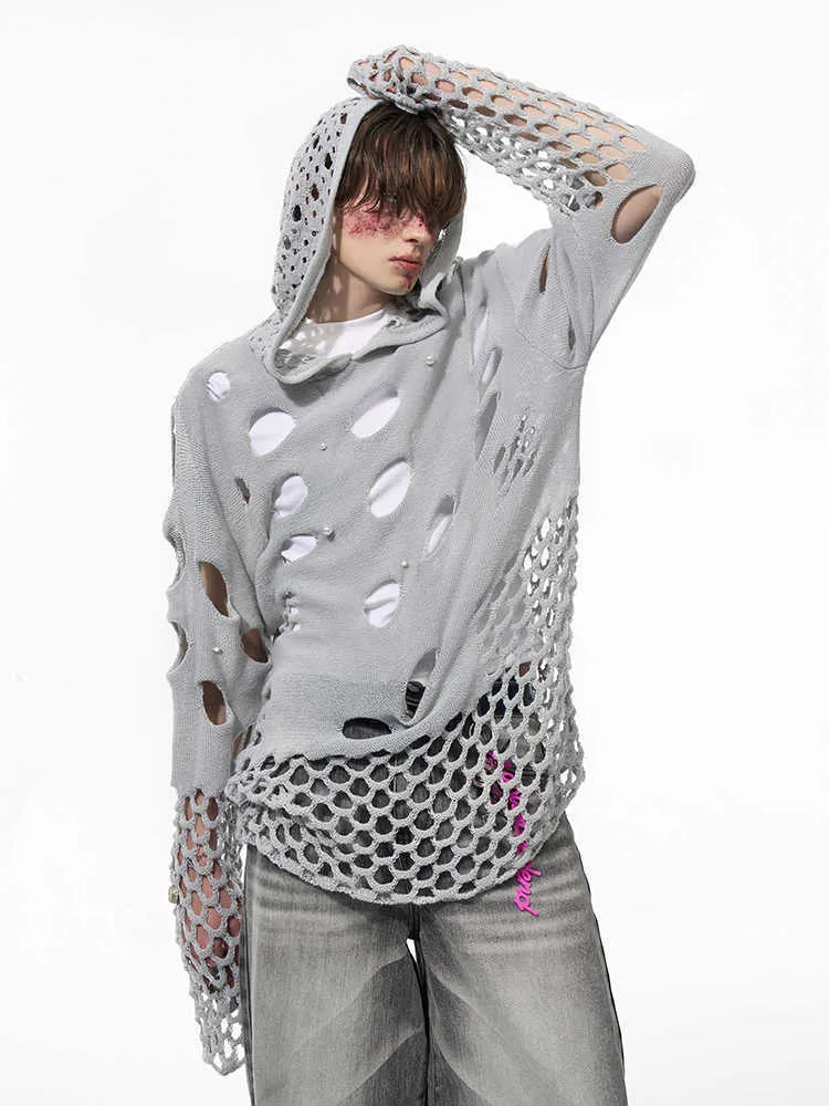 Black men's hollow knit hoodie with pearl decoration on the hood, showing loose fit.