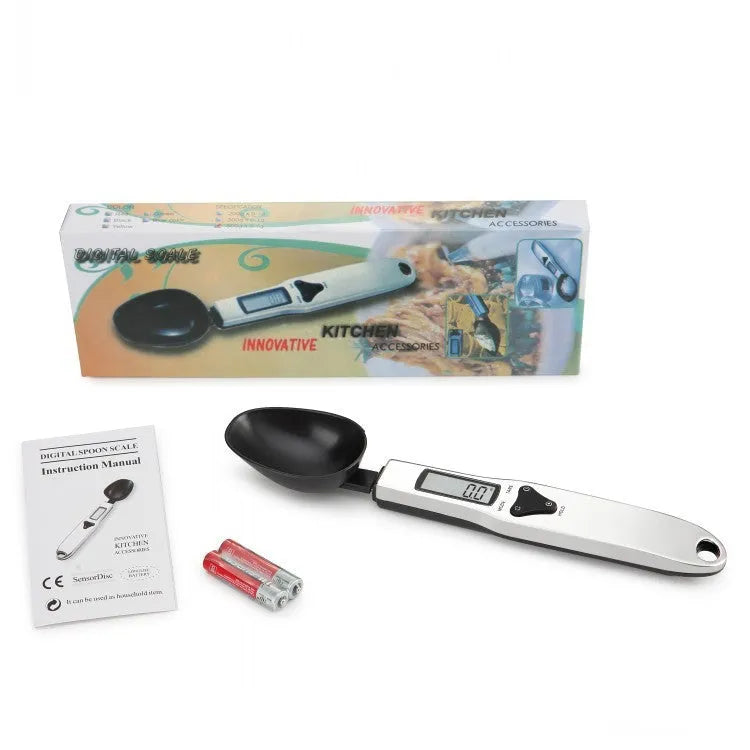 Digital smart measuring spoon with LCD screen showing weight, placed next to mixing bowl.