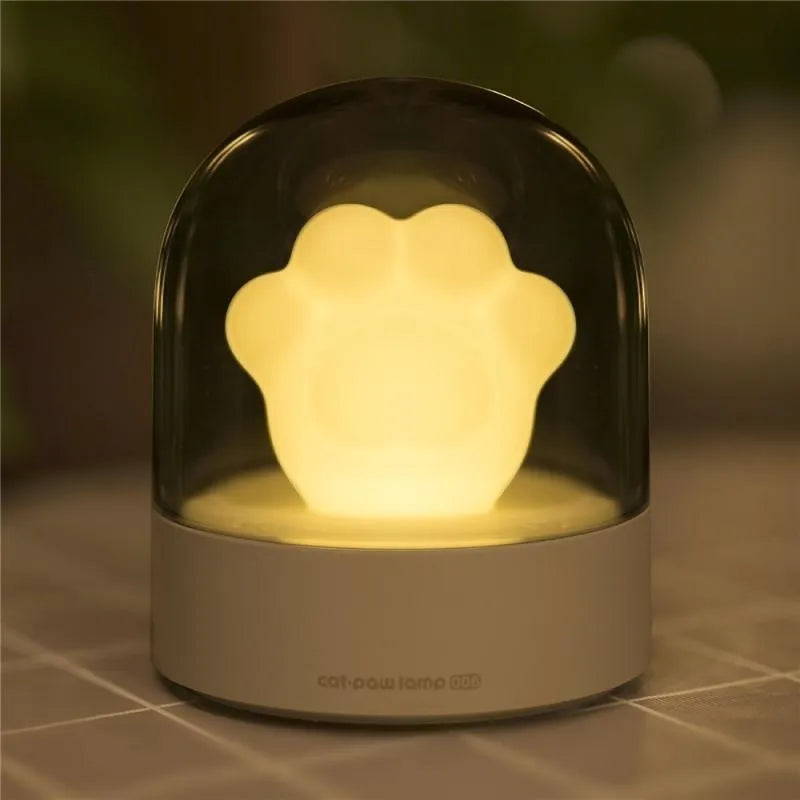 Grey and pink cat paw shaped night light with USB charging port and music box functions