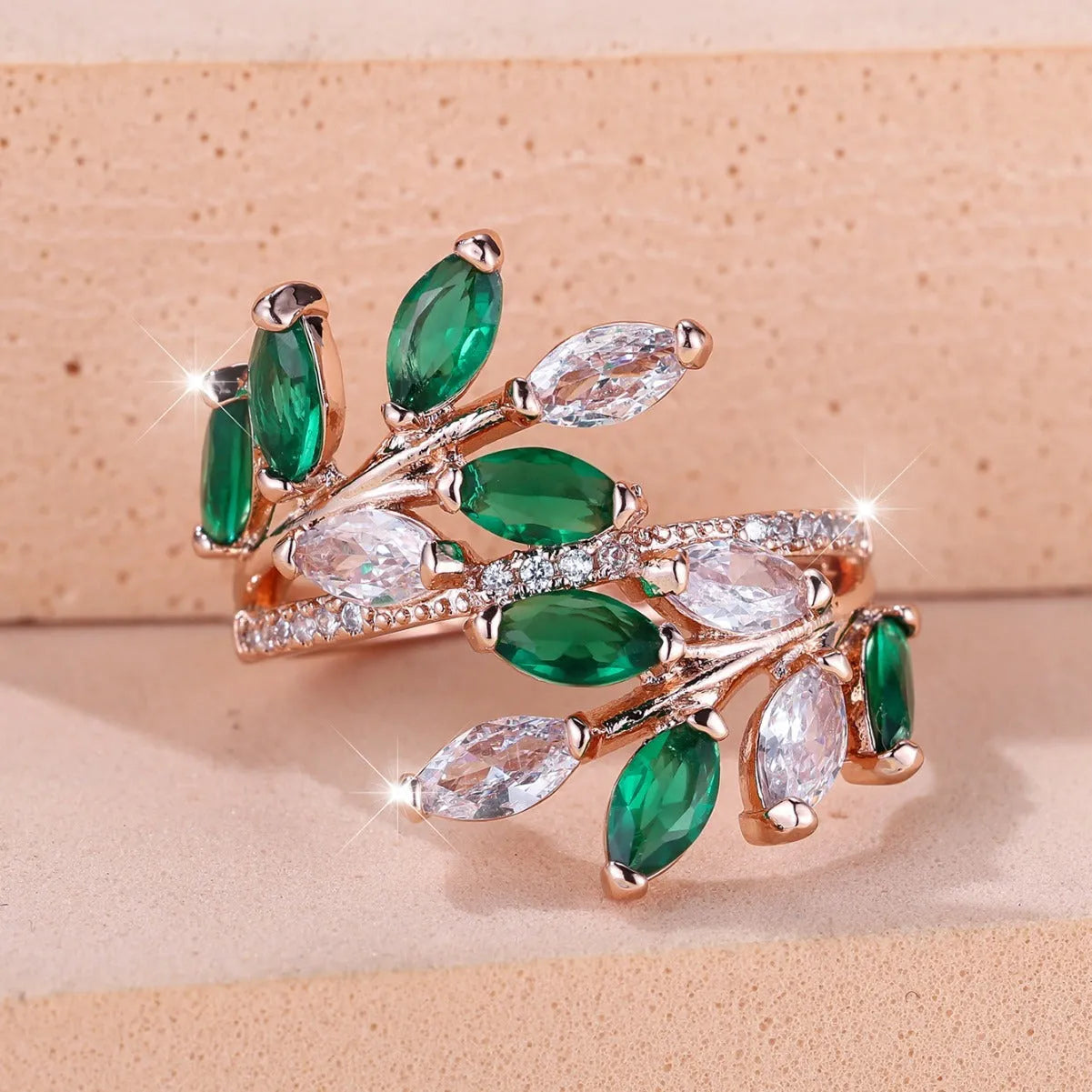 Adjustable copper ring with a detailed leaf design and zircon accents in various colour options.