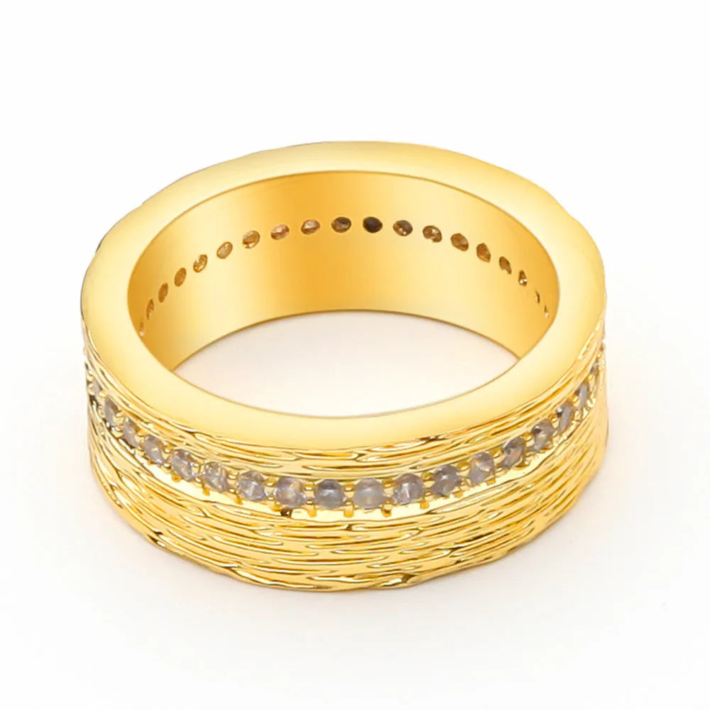 Gold geometric women's zircon ring made from electroplated copper on a grey background.