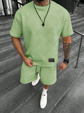 Men's short sleeve top and shorts suit in a polyester blend fabric on a mannequin