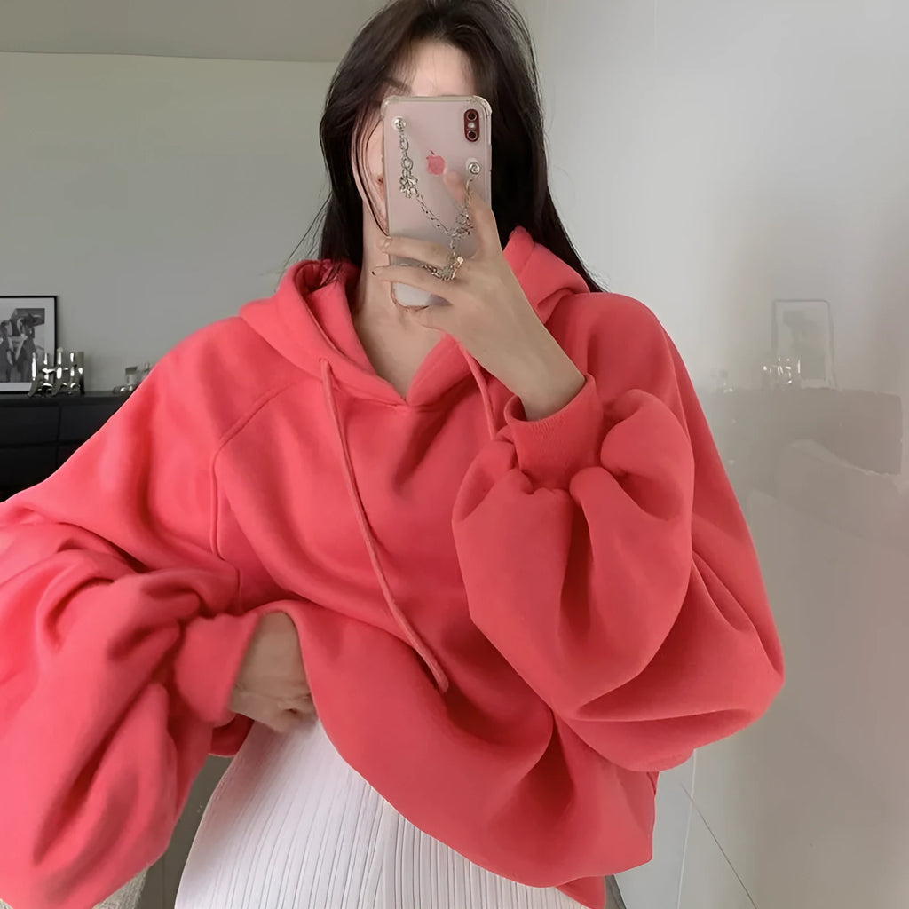 Watermelon red women's sleeveless hooded sweater made from mulberry silk on a hanger.