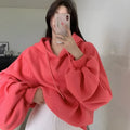 Watermelon red women's sleeveless hooded sweater made from mulberry silk on a hanger.