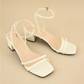Beige women's stiletto sandals with chunky block heel and square toe design, showing adjustable ankle buckle closure