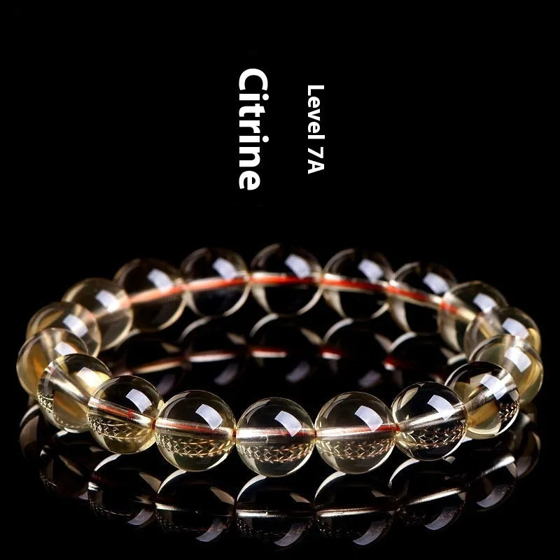 Natural citrine scattered beads ball bracelet on wrist, showing polished beads in 7A grade colour.