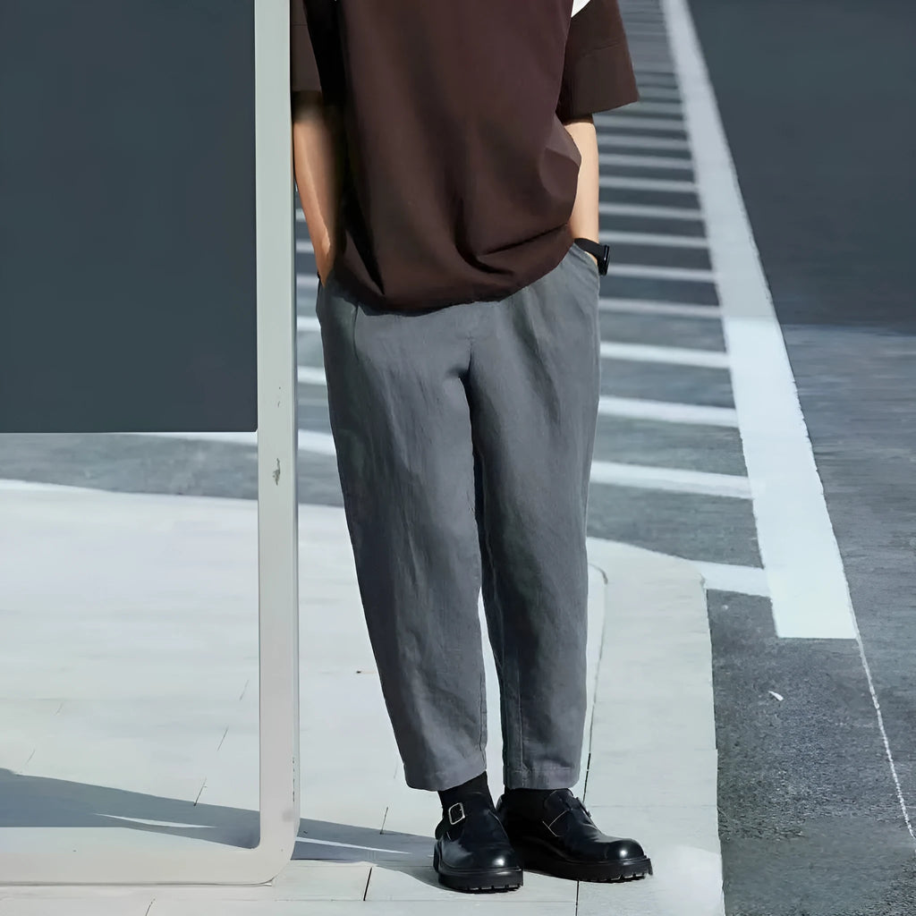 Men's loose-fitting straight-leg casual pants in beige colour with an elasticated drawstring waistband.