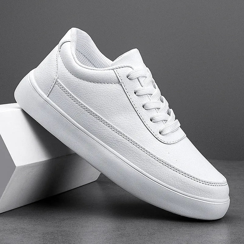 Women's white leather flat casual shoes with front lace-up design on a neutral background.