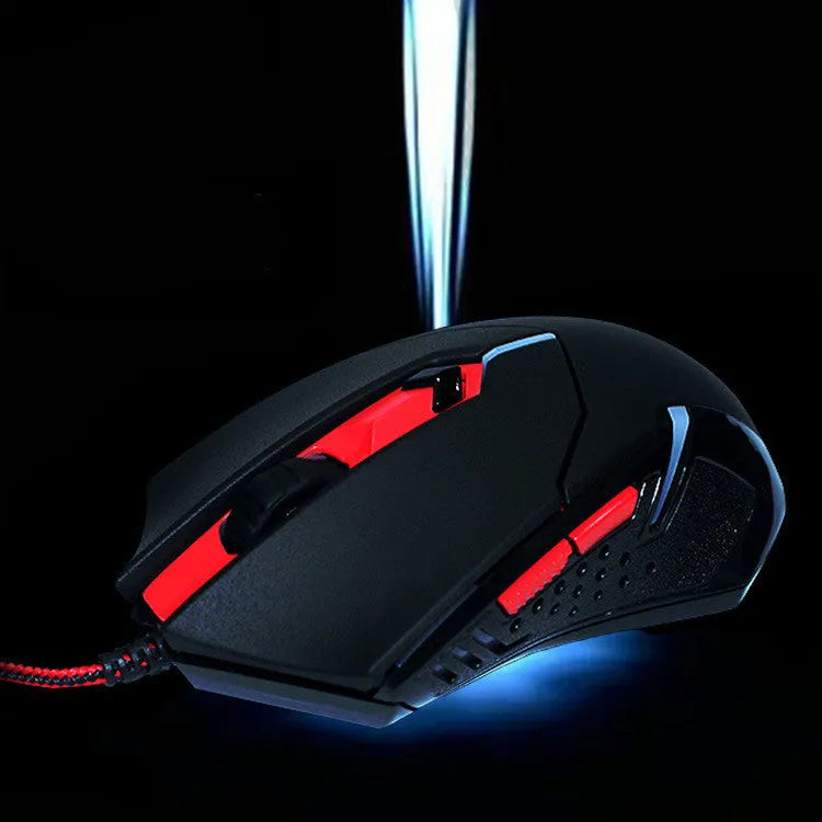 Black and red USB wired optical gaming mouse with six buttons on a desktop.