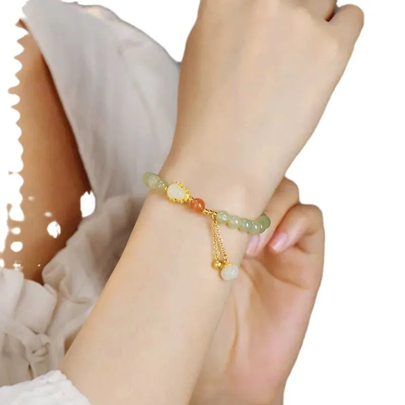 Jade women's bracelet with gold plated gourd charm and fu character decoration