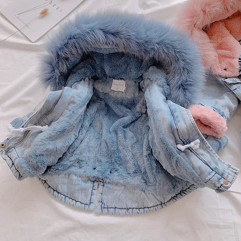 Blue denim coat for girls with a hood and plush fleece lining, shown on a hanger.