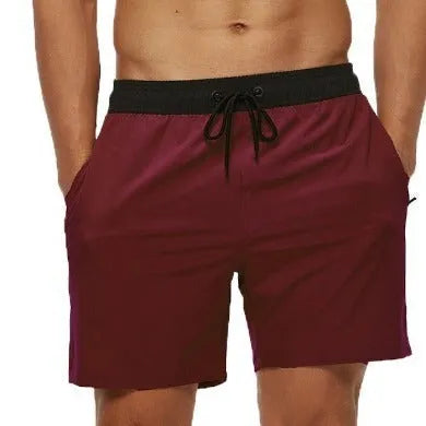 Men's blue stitching waist athletic shorts with drawstring and zipper pockets laid flat.