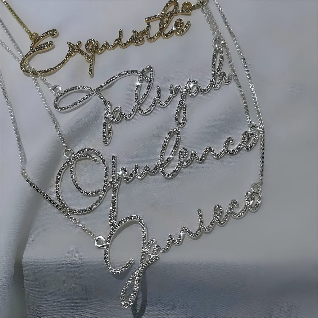Personalised stainless steel name necklace with diamond-studded English letters on a chain.