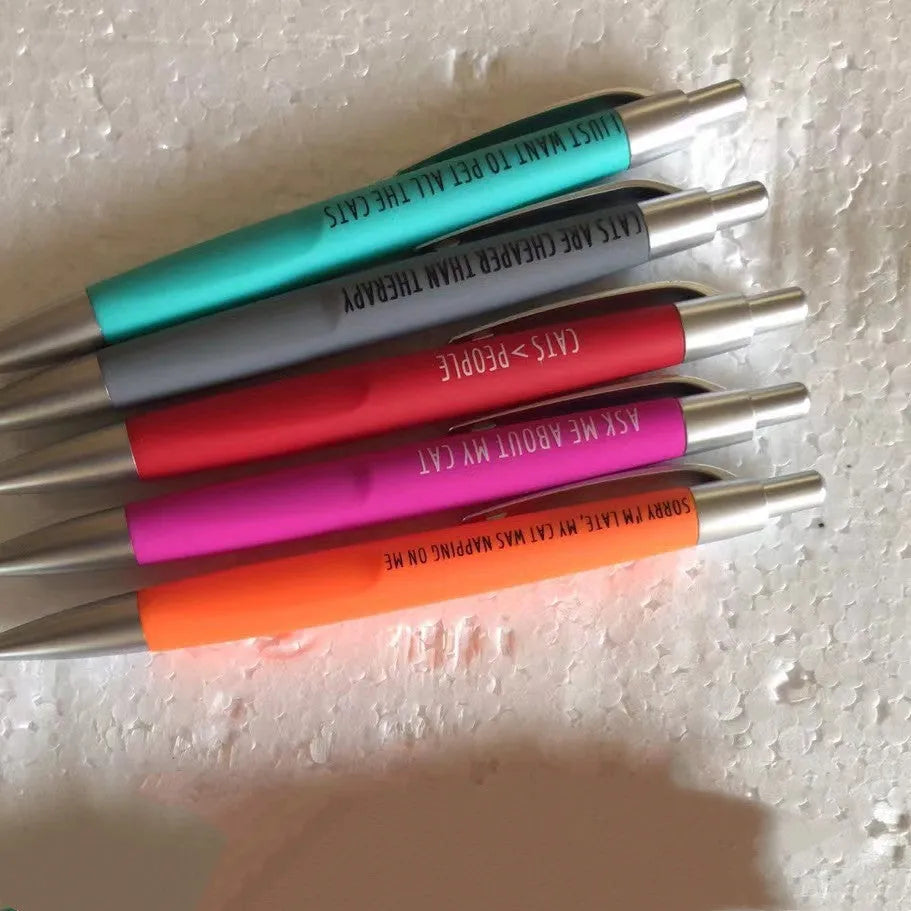 Set of five coloured push action automatic pens and a beaded storage bag