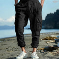 Men's linen casual trousers with ankle-tied cuffs and multiple pockets in a solid colour.