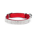 A velvet cat collar with rhinestones, shown in red, with an adjustable buckle.
