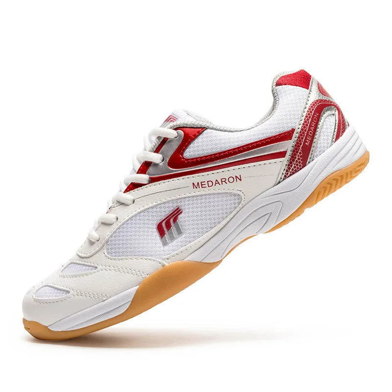 White table tennis sneakers with mesh upper and rubber sole in red or blue accents
