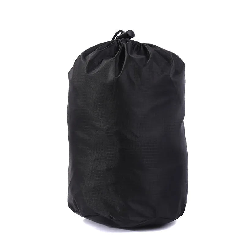 Folding portable mesh hammock in black, set up outdoors, with three supporting straps