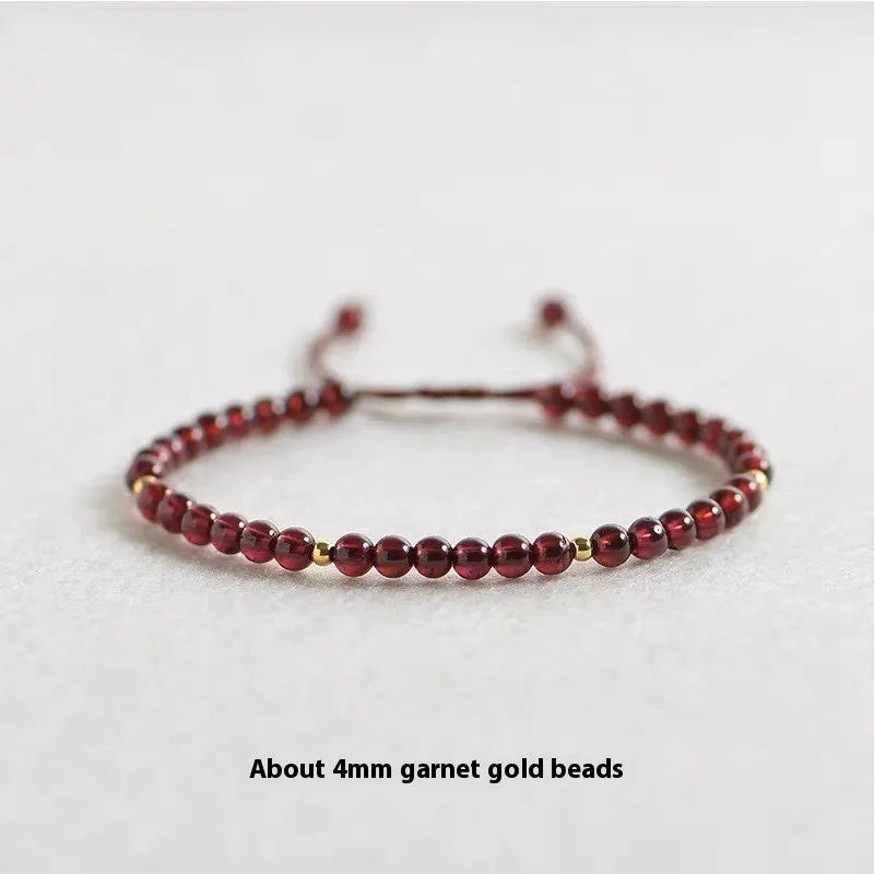 Hand-woven garnet red bracelet with flexible wire rope construction and Chinese national tide design
