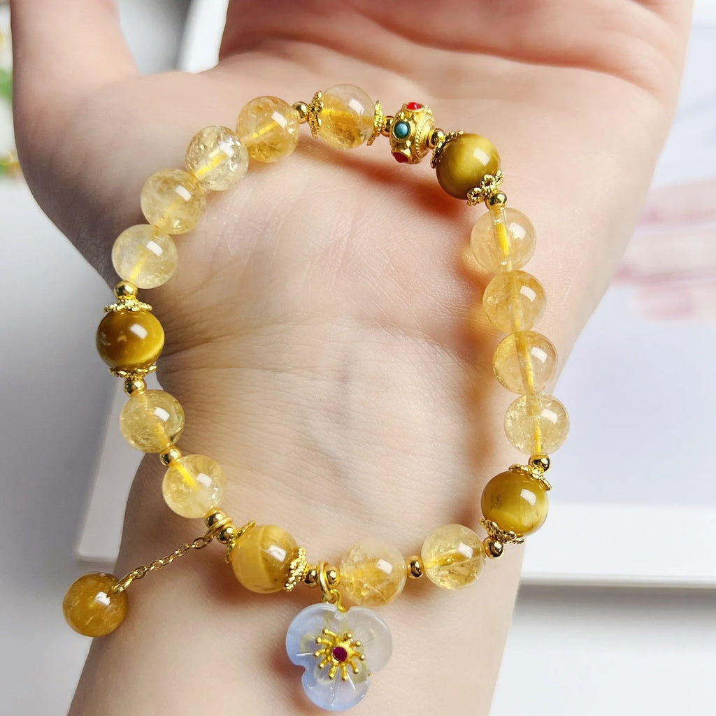 Handmade citrine colour crystal bracelet with floral and tassel detailing for women.
