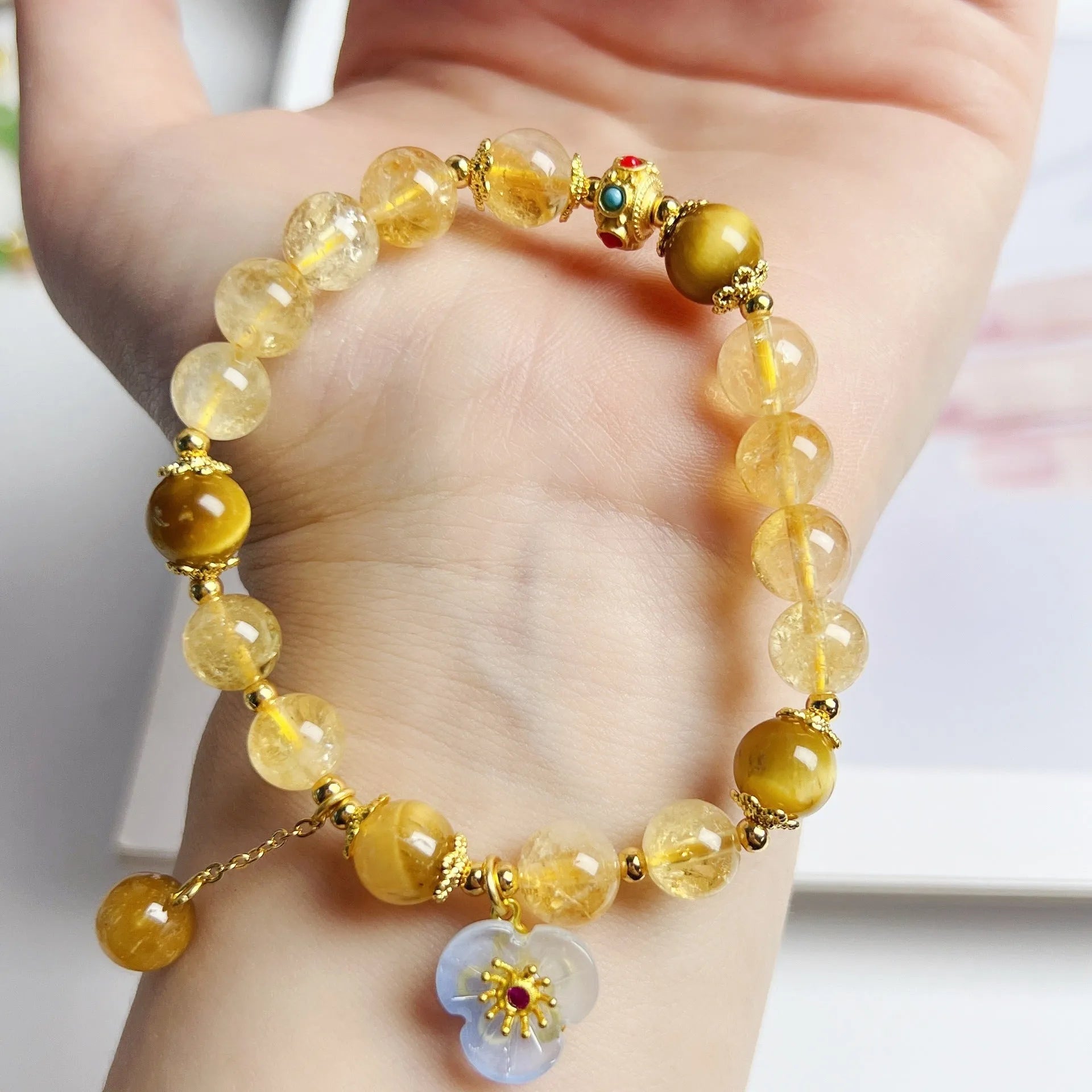 Handmade citrine colour crystal bracelet with floral and tassel detailing for women.