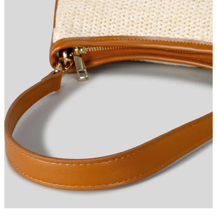 Khaki coloured hand-woven straw crossbody bag with a single strap and an internal phone pocket.