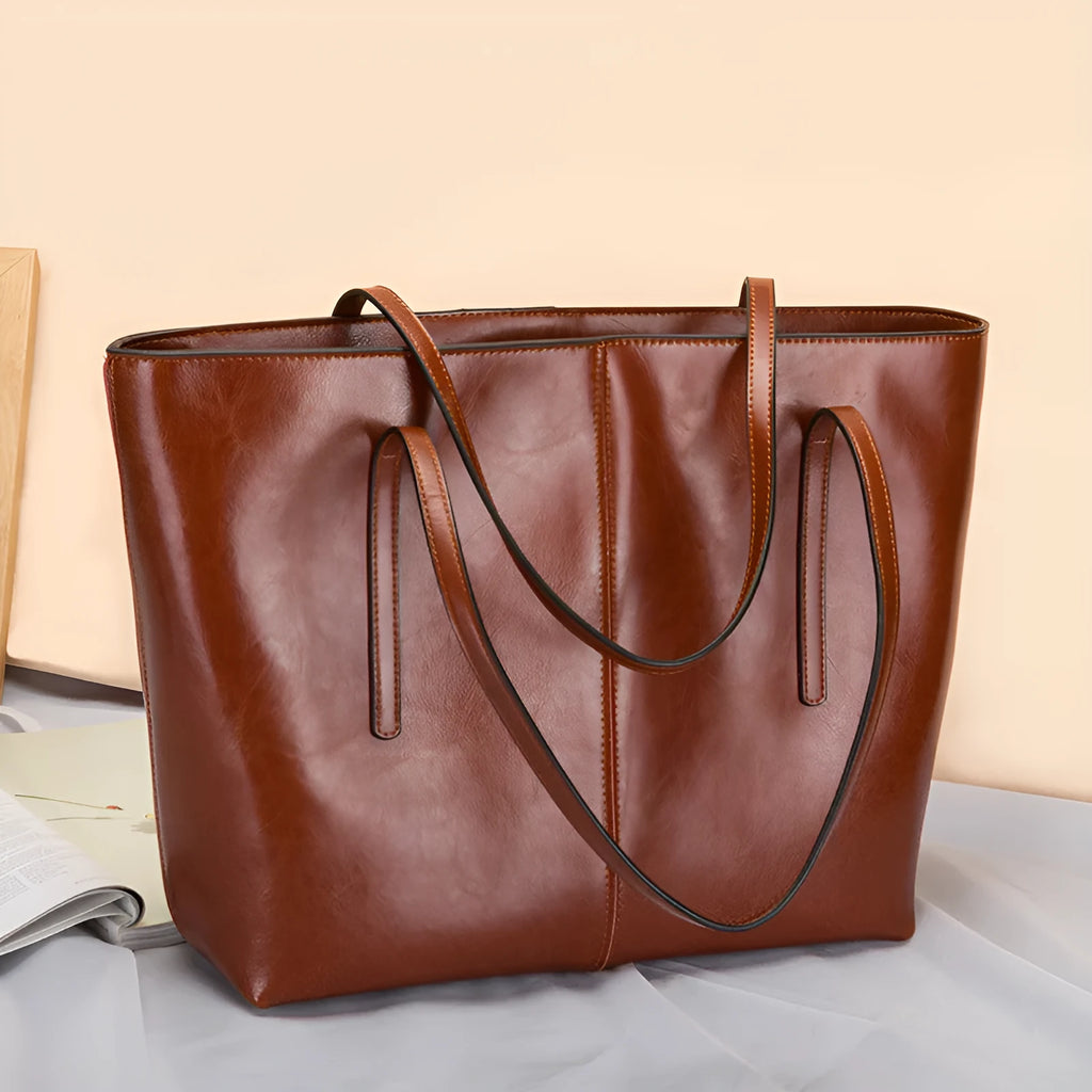 Women's retro style cowhide shoulder bag in horizontal square shape with multiple internal compartments