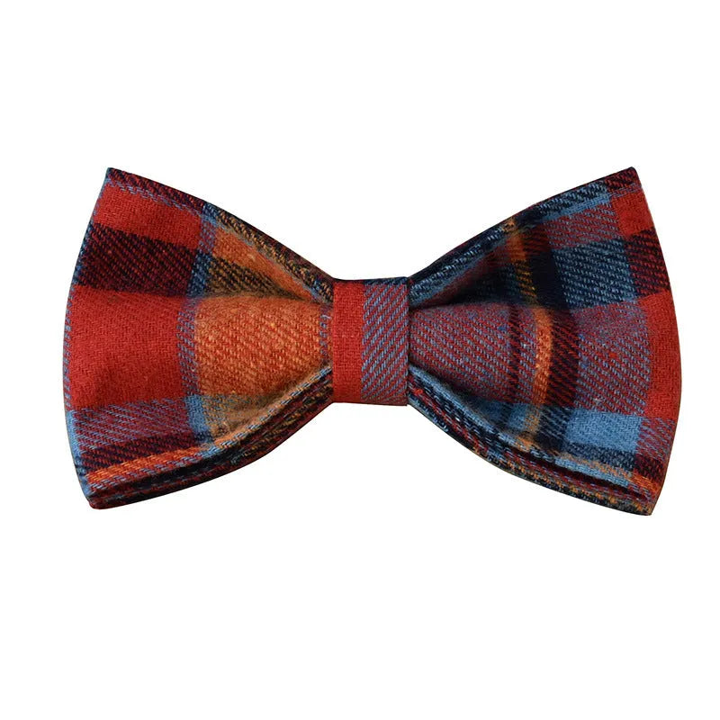 Blue background velvet plaid dog collar with a silver alloy metal buckle on a white surface.