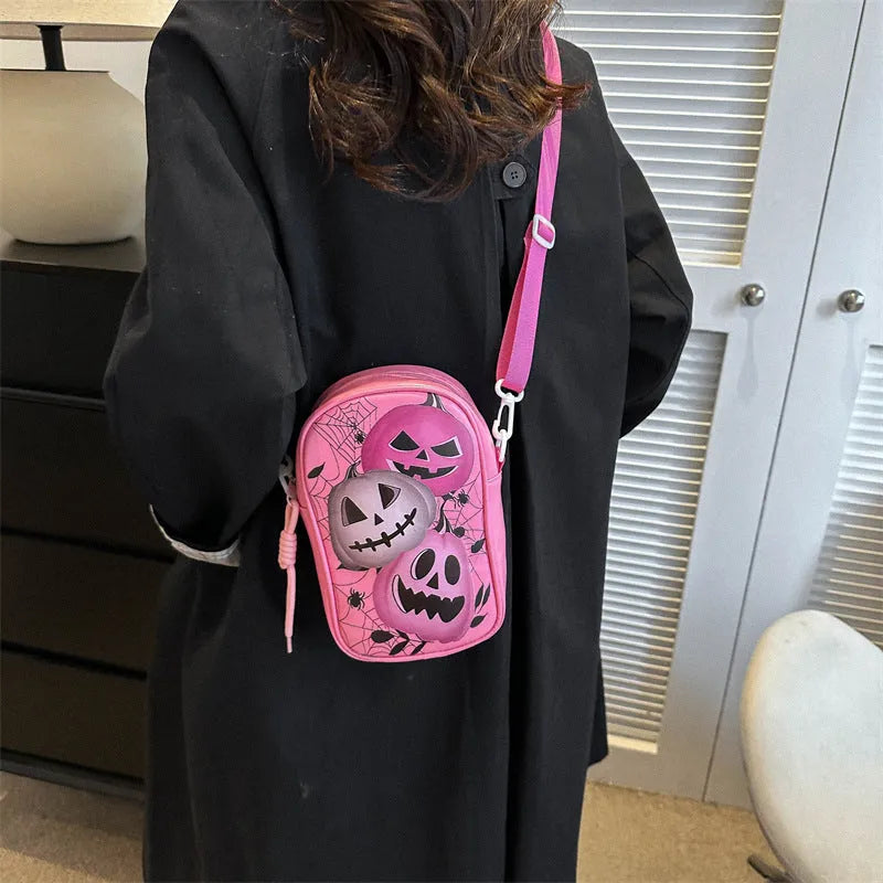 Black Halloween-themed mini crossbody bag with cartoon pumpkin, ghost, and bat prints.