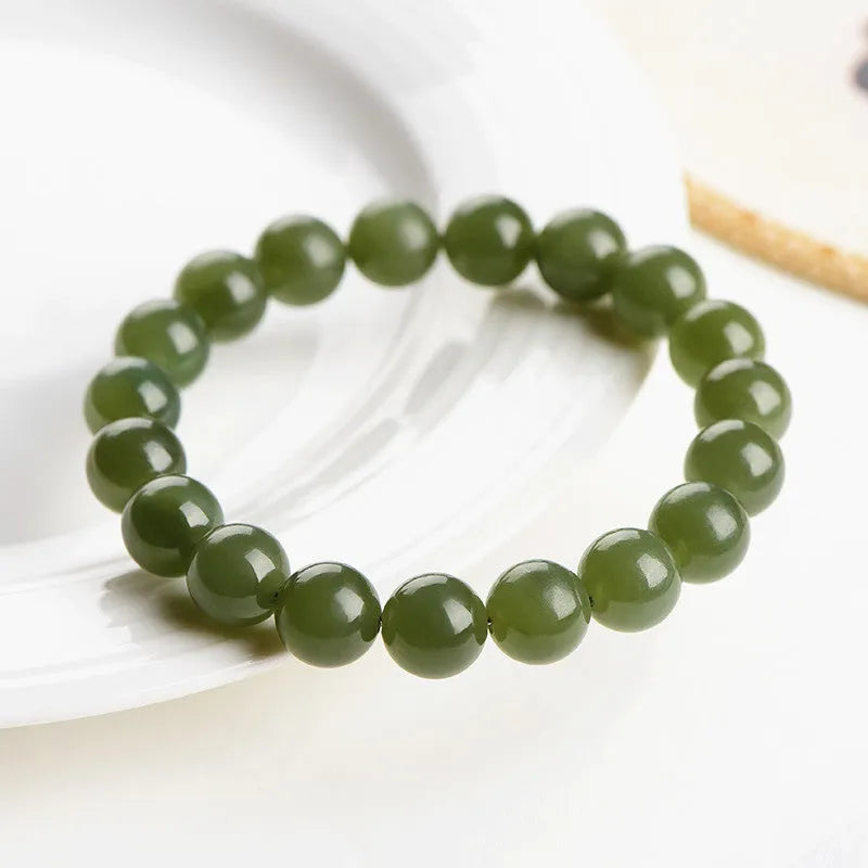 Unisex Hetian jade ball bead bracelet in ice clear colours, showing polished spherical beads on a string.