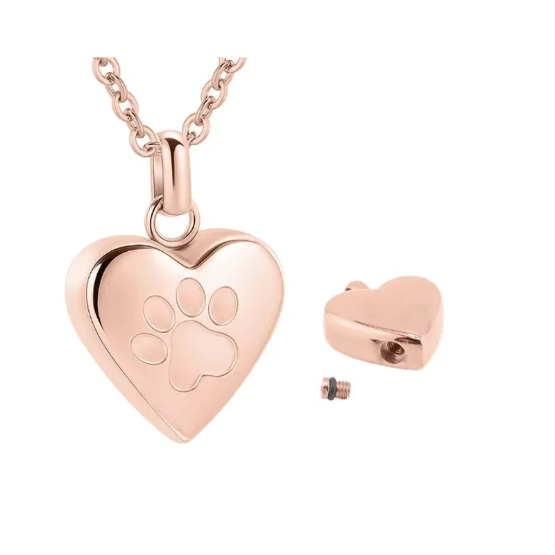 Silver titanium steel heart casket necklace with paw print design on a black background.