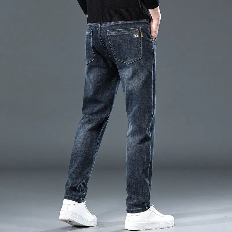 Man wearing slim straight blue grey casual trousers with a zip fly and mid waist.