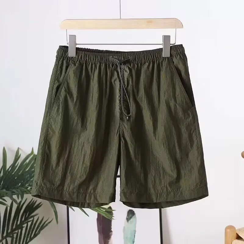 Men's quick-drying straight-leg sports shorts in army green, shown flat.