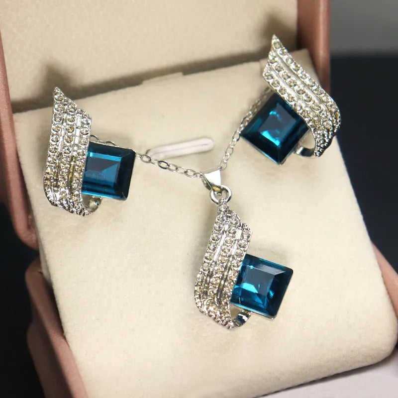Women's electroplated necklace and earring set with alloy pendant and glass accents on cross chain
