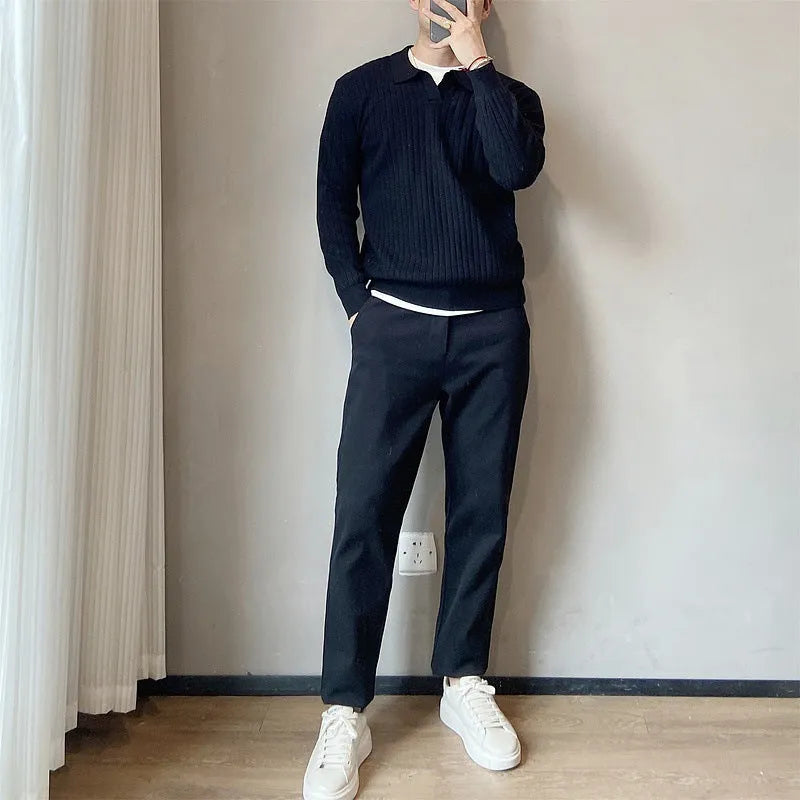 Men's loose grey knitted pullover sweater with a lapel collar on a hanger.