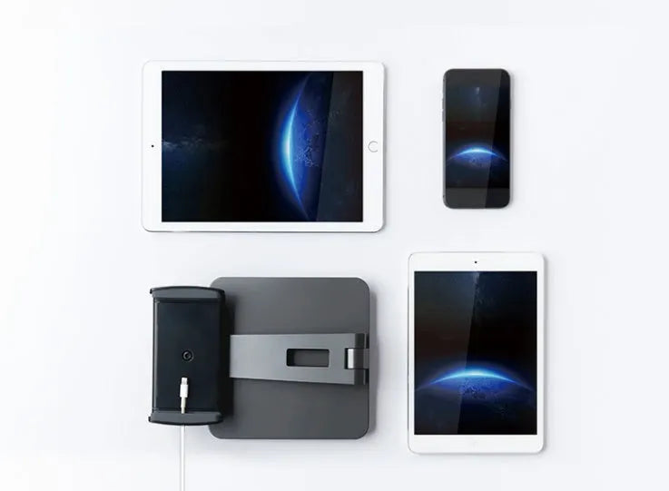 Silver foldable aluminium phone tablet stand with 360-degree rotating bracket on a desktop.