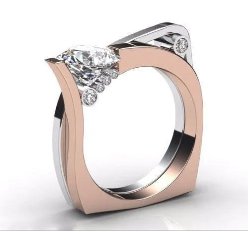 Rose gold geometric couple ring with inlaid zircon stones on a grey background.