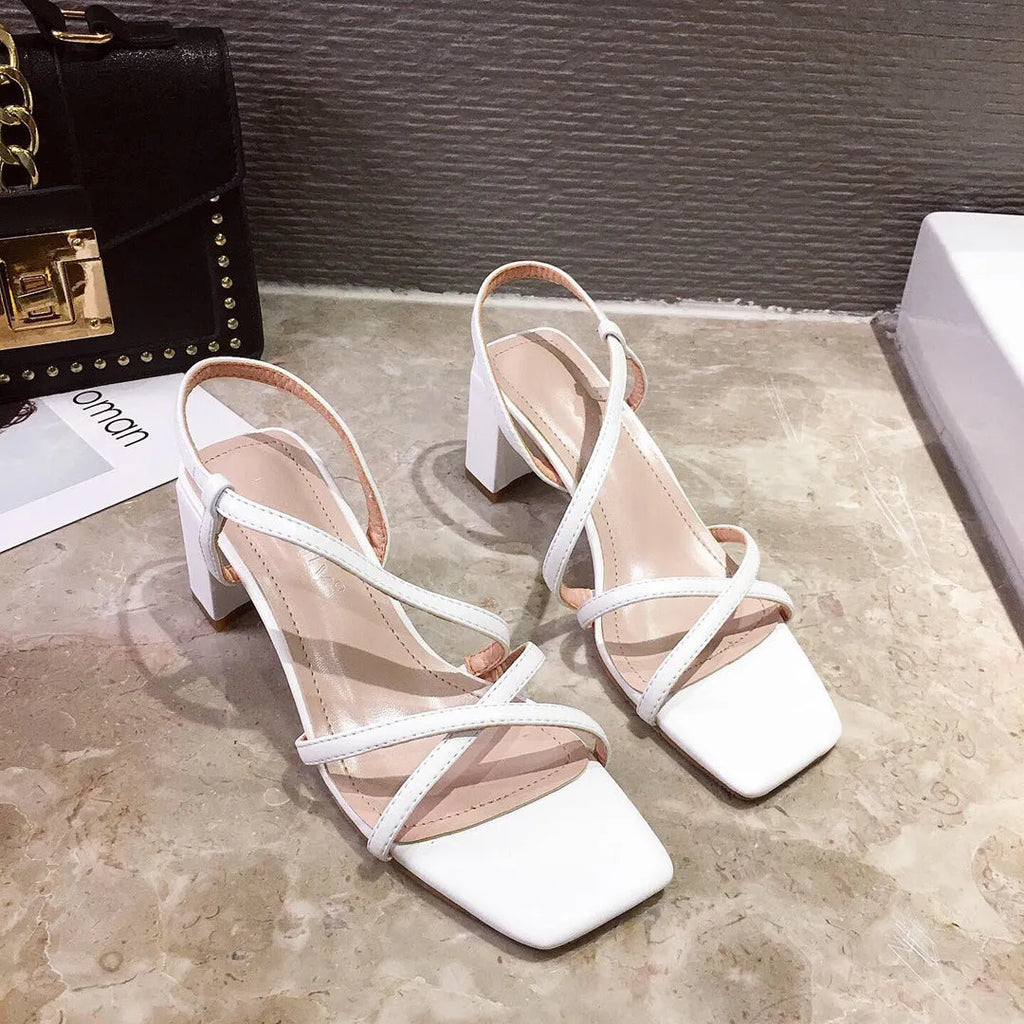 Women's white thick heel sandals with an 8cm high block heel and a backless slide-on design.
