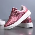 Rose gold sequin platform sneakers with round toe and thick sole.