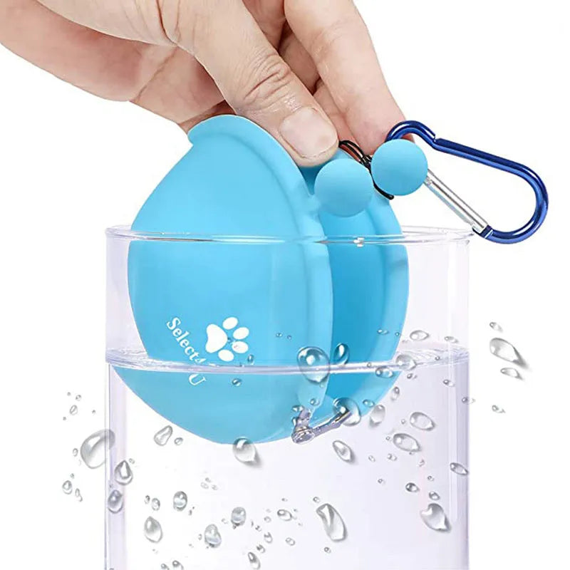 Yellow silicone dog training treat pouch with hook-and-loop closure, shown clipped to a waistband.