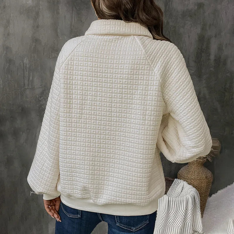 Beige women's polo collar sweater with long sleeves and a textured knit fabric.