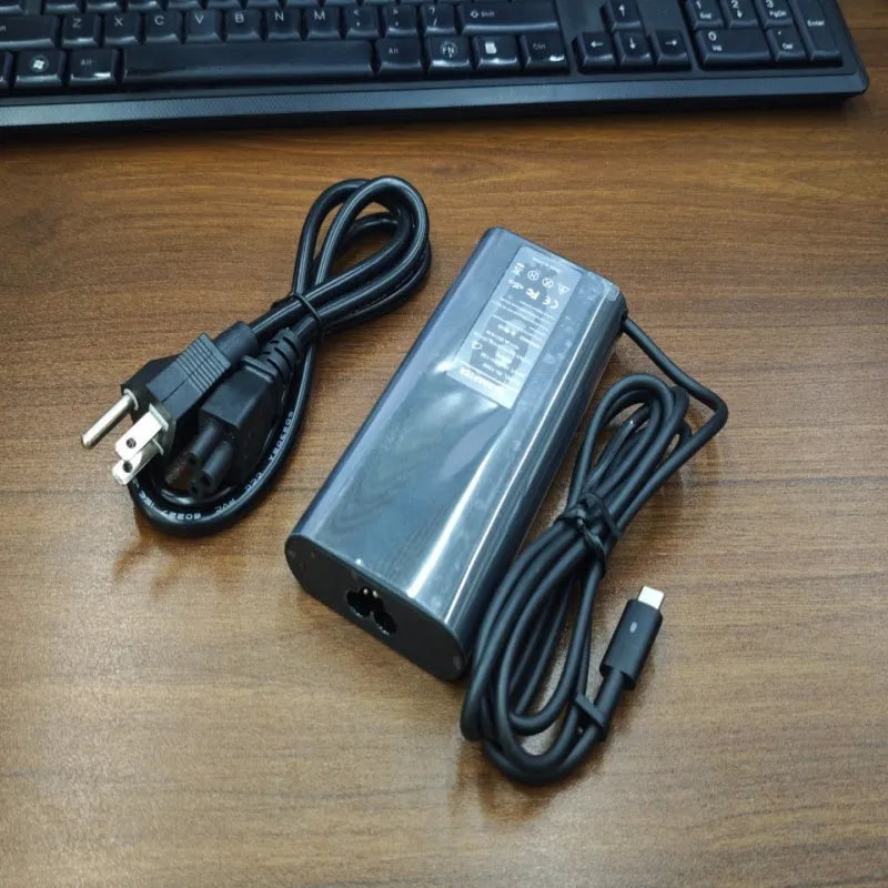 Black 65W Type-C laptop power adapter with set of US UK EU AU ZA plug heads