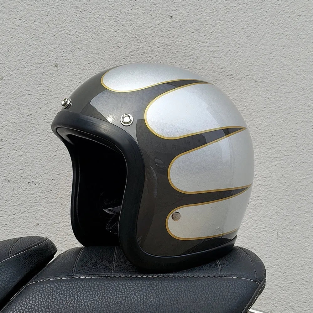 Retro-style open face motorcycle helmet in fibreglass, shown in a selection of colours including cement grey and matte black.