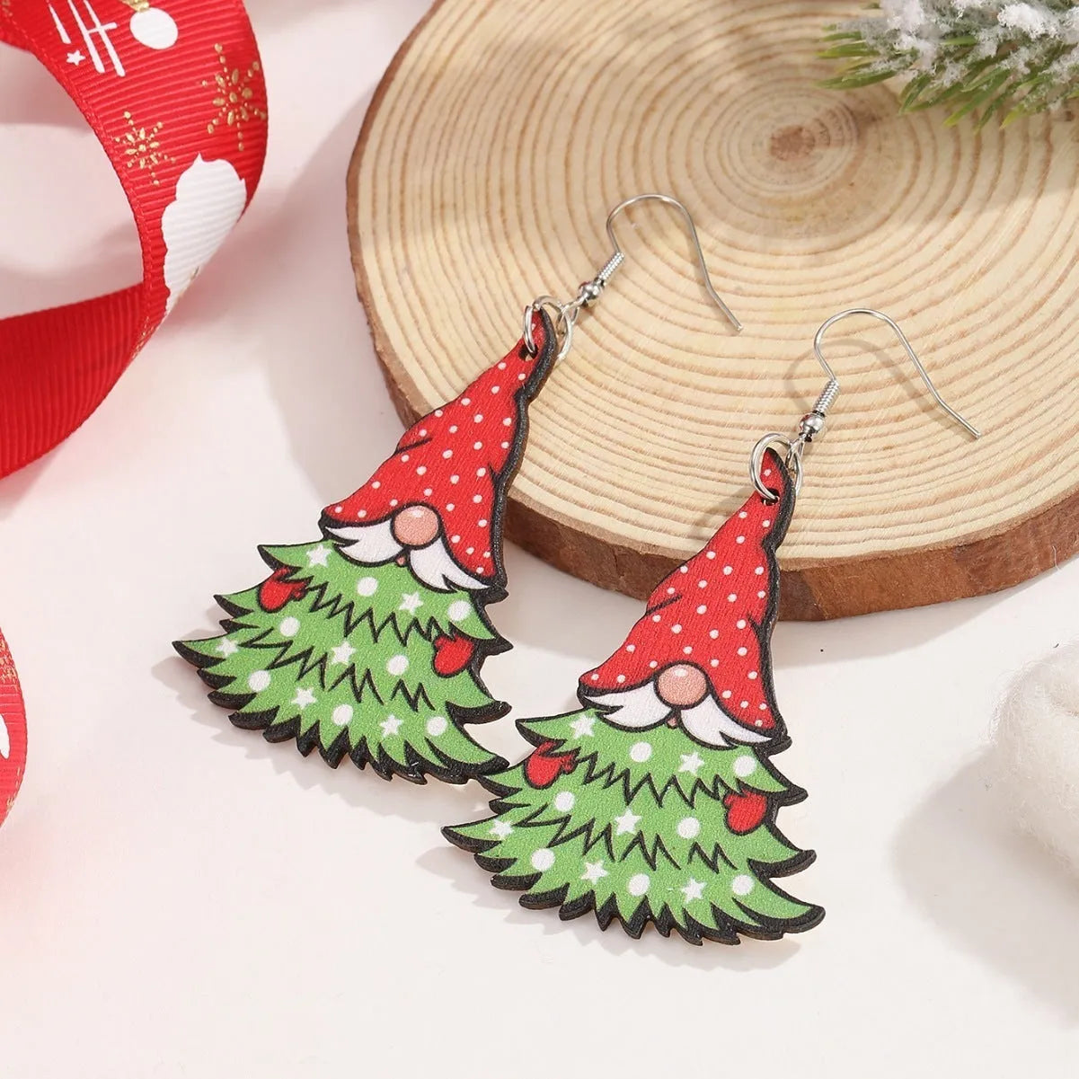 Wooden Christmas earrings with printed geometric designs featuring Christmas tree and snowman patterns