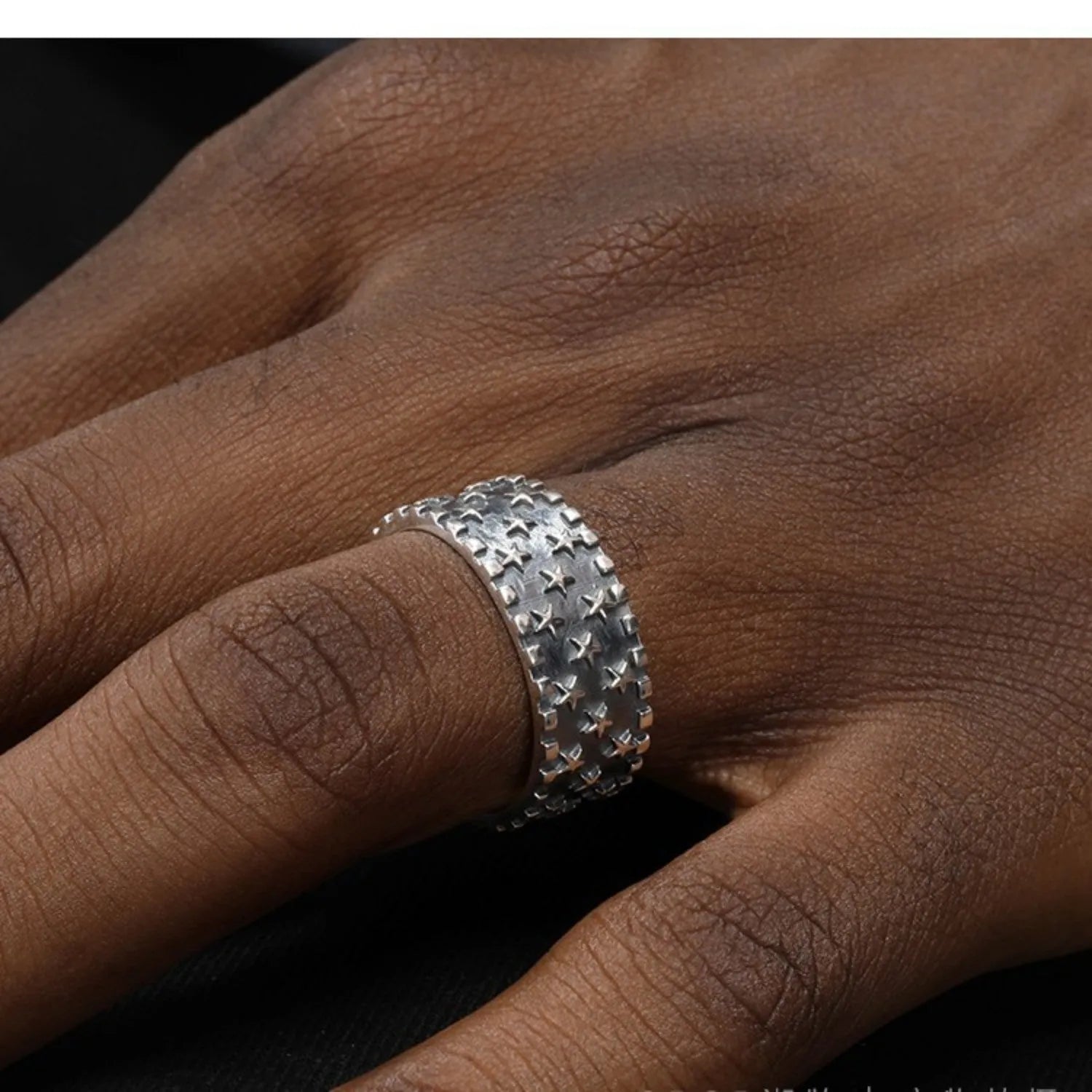 Sterling silver ring with geometric multi star pattern and adjustable opening.