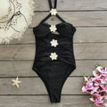 Women's black high-waisted one-piece swimsuit with a detachable short skirt and hollow-out tube top.