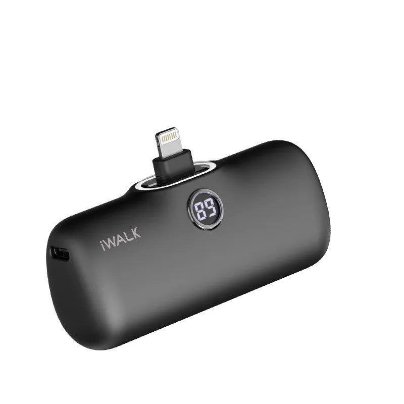 Compact white lipstick-shaped power bank showing screen display next to a smartphone.