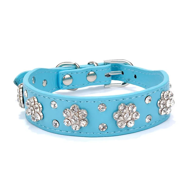 Soft black PU leather dog collar with sparkling pink rhinestone flower studs and a metal D-ring.